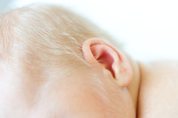 Close up detailed photo of a newborn babies ear and hair